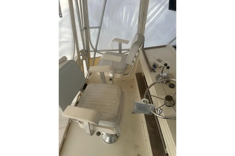 Slide: The Image of 1988 Viking 35 Convertible boat helm with steering wheel and seating. - 19