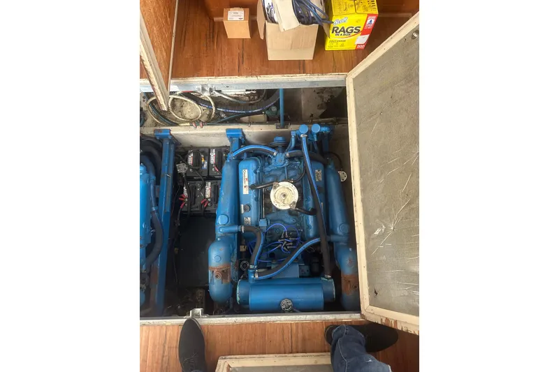 Slide: The Image of Engine compartment of 1988 Viking 35 Convertible boat with visible blue engine components. - 21