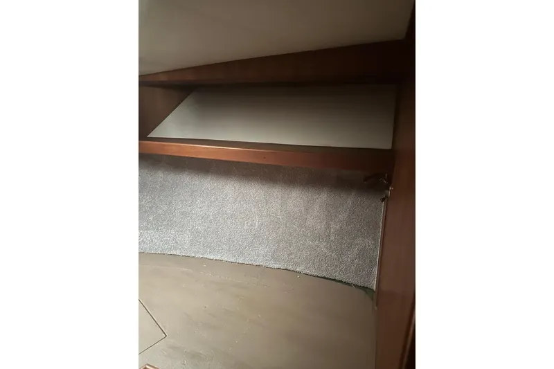 Slide: The Image of Interior cabin of 1988 Viking 35 Convertible boat with wooden and carpeted surfaces. - 25