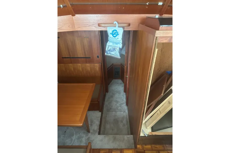 Slide: The Image of Interior of 1988 Viking 35 Convertible boat with wooden furnishings and carpeted floor. - 28
