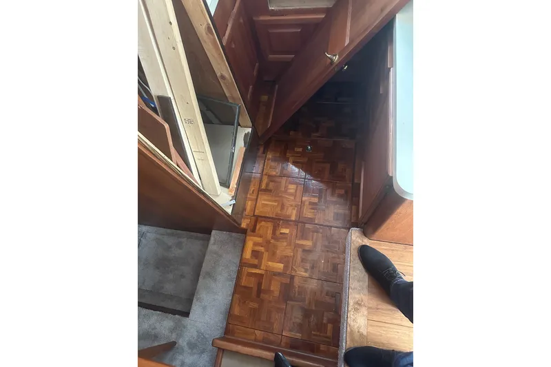 Slide: The Image of Interior view of 1988 Viking 35 Convertible boat with wooden flooring and cabinetry. - 29