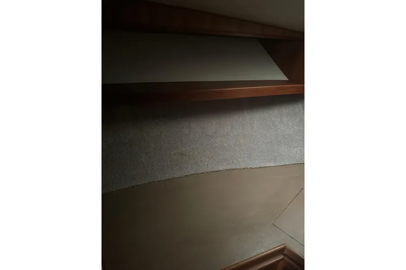 Slide: The Image of 1988 Viking 35 Convertible interior with wooden shelf and carpeted wall. - 30