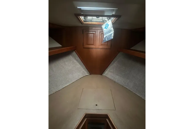 Slide: The Image of Interior of 1988 Viking 35 Convertible boat with wood paneling and overhead hatch. - 31