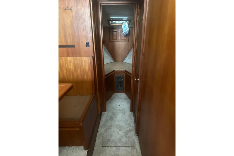Slide: The Image of Interior of 1988 Viking 35 Convertible boat with wood paneling and carpeted floor. - 32