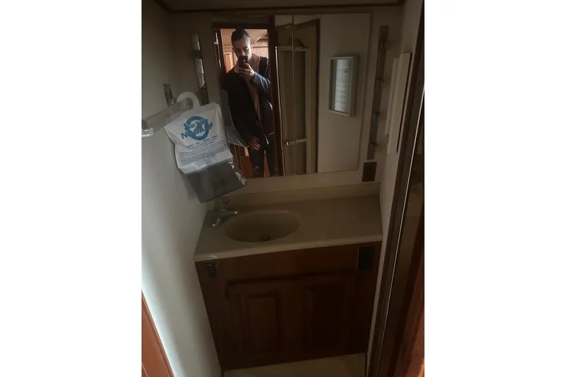 Slide: The Image of Bathroom interior of 1988 Viking 35 Convertible yacht with sink and mirror. - 34