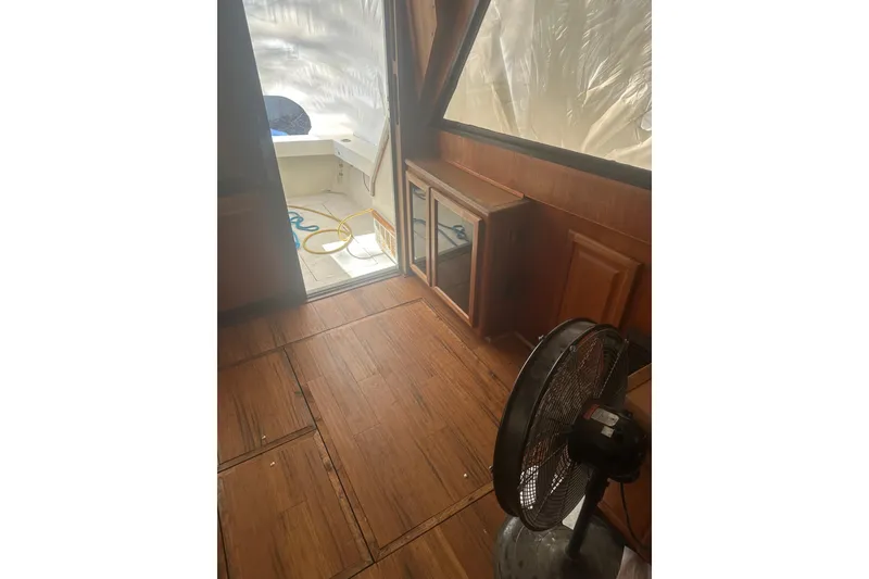 Slide: The Image of 1988 Viking 35 Convertible interior with wooden flooring and fan. - 38