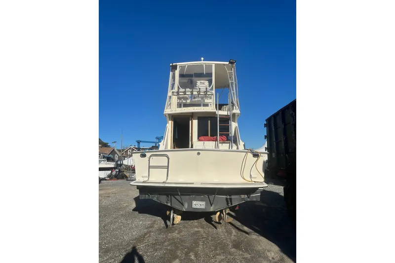Slide: The Image of 1988 Viking 35 Convertible boat on trailer under bright sun. - 5