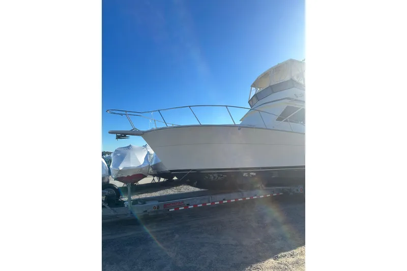 Slide: The Image of 1988 Viking 35 Convertible boat on trailer under clear blue sky. - 7