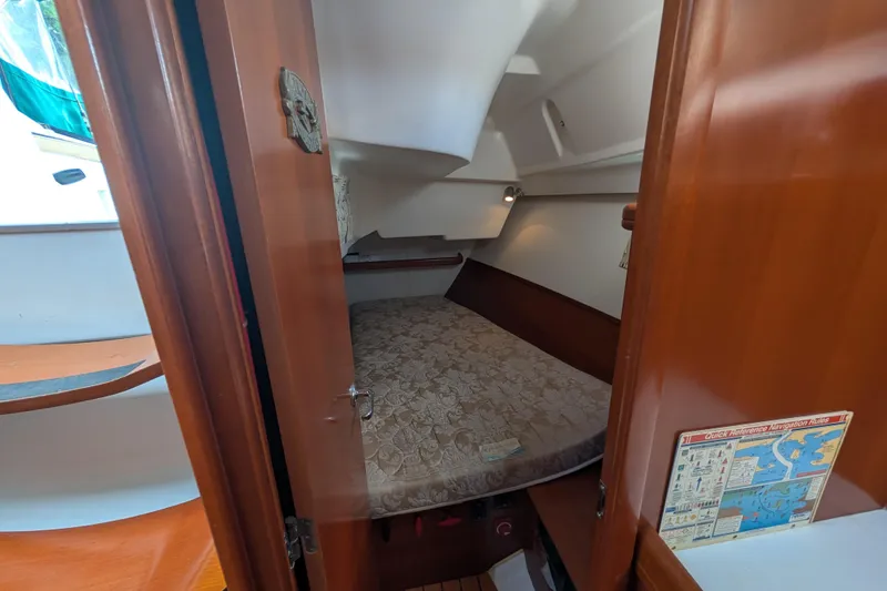 Slide: The Image of Cozy cabin interior of 2006 Beneteau Oceanis Clipper 373 sailboat, featuring a comfortable bed. - 15