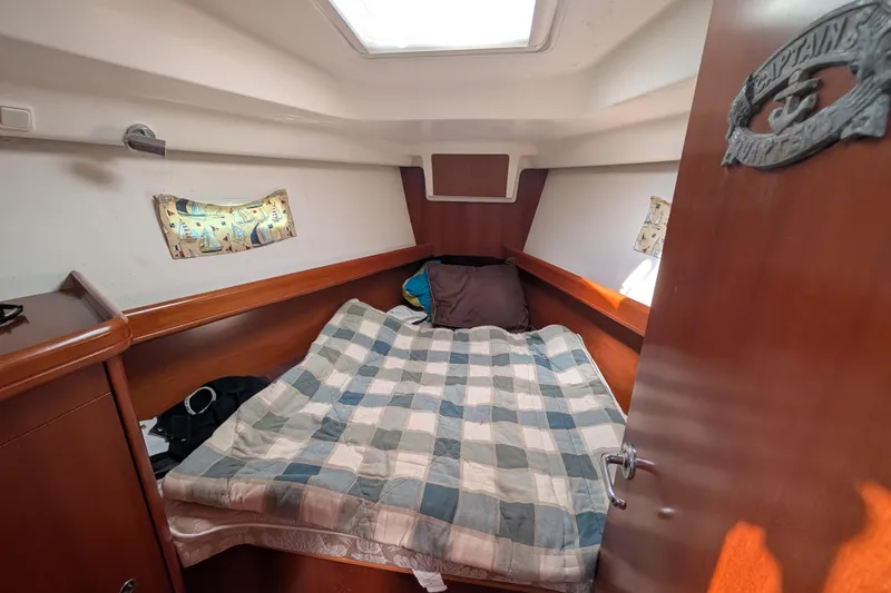 Slide: The Image of Cozy cabin interior of 2006 Beneteau Oceanis Clipper 373 sailboat with bed and nautical decor. - 23