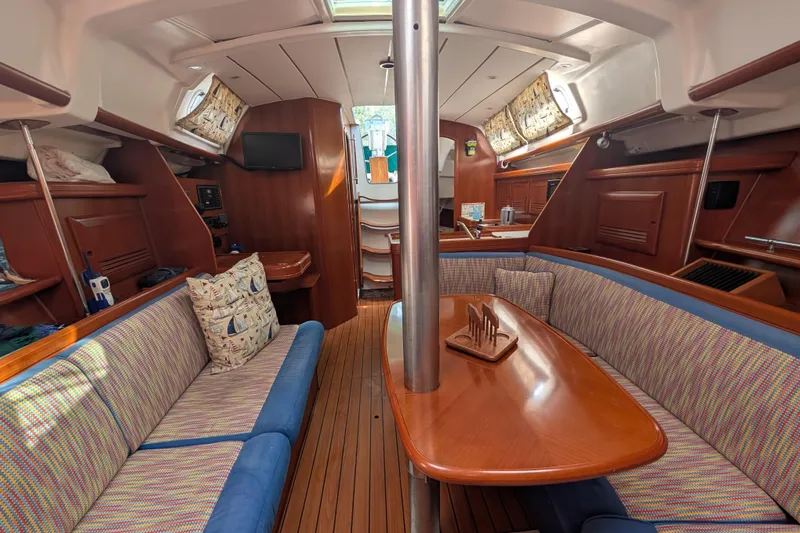 Slide: The Image of Interior of 2006 Beneteau Oceanis Clipper 373 sailboat with cozy seating and wooden finishes. - 24