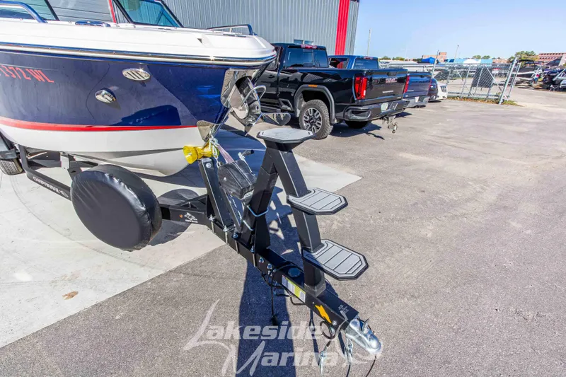 Slide: The Image of 2021 Chaparral 267 SSX boat on trailer at marina parking lot. - 11
