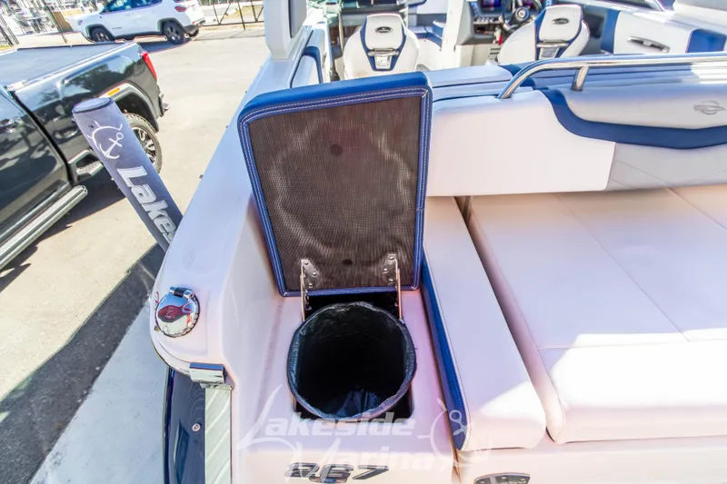 Slide: The Image of 2021 Chaparral 267 SSX boat interior with seating and storage compartment. - 14