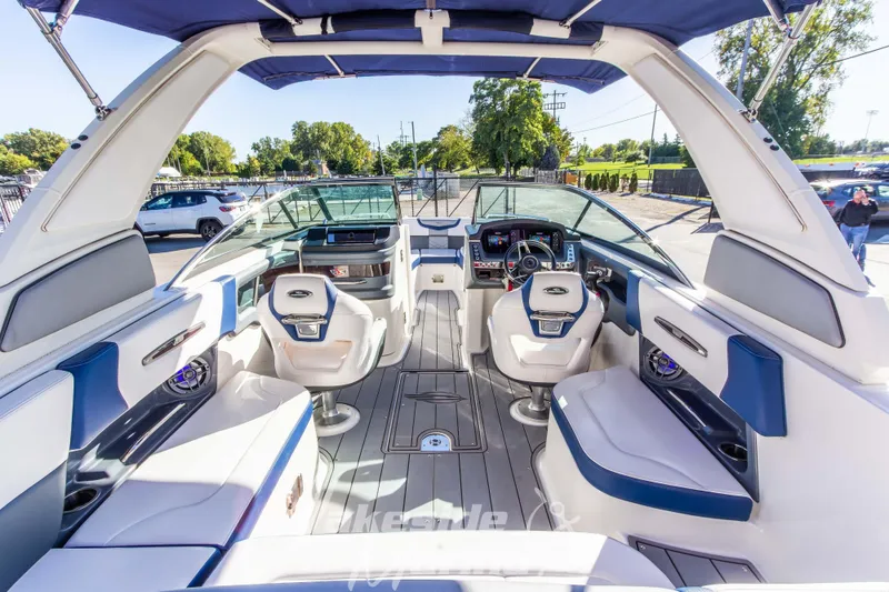 Slide: The Image of Interior view of 2021 Chaparral 267 SSX boat, featuring luxurious seating and modern dashboard. - 17