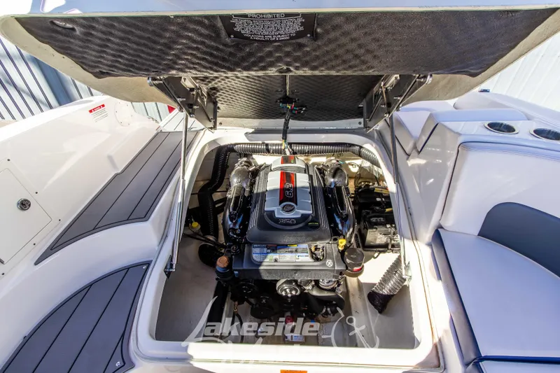 Slide: The Image of 2021 Chaparral 267 SSX boat engine compartment with open hatch, showcasing engine details. - 20