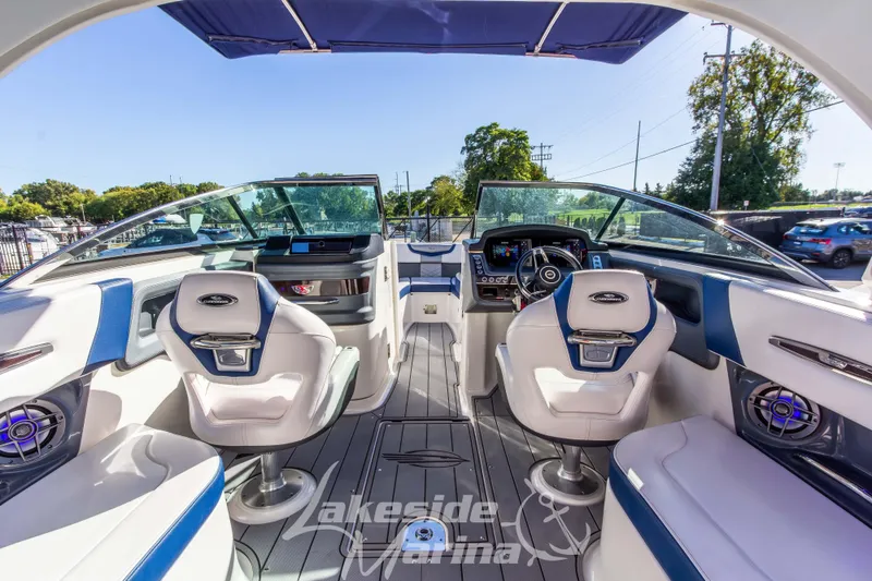 Slide: The Image of 2021 Chaparral 267 SSX boat interior with modern dashboard and seating. - 21