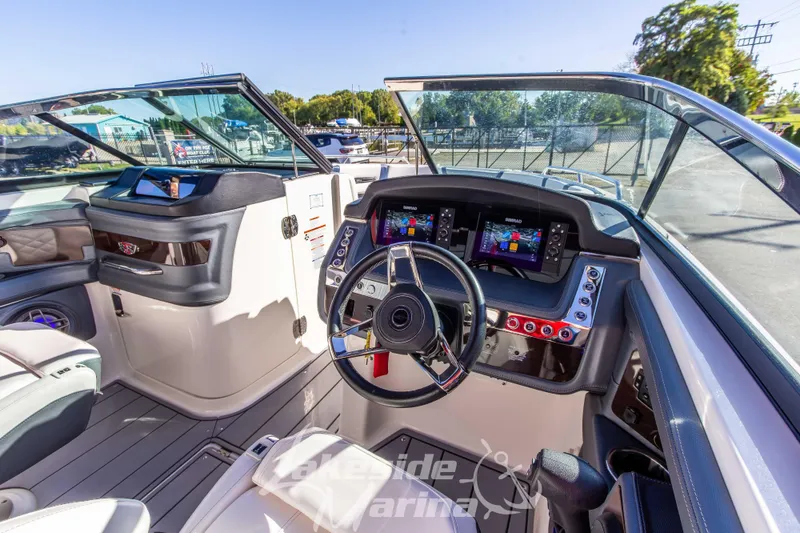 Slide: The Image of 2021 Chaparral 267 SSX boat cockpit with modern dashboard and steering wheel. - 24