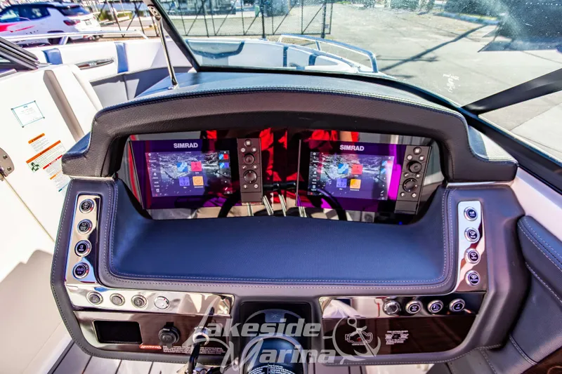 Slide: The Image of 2021 Chaparral 267 SSX boat dashboard with dual Simrad displays and control panel. - 25