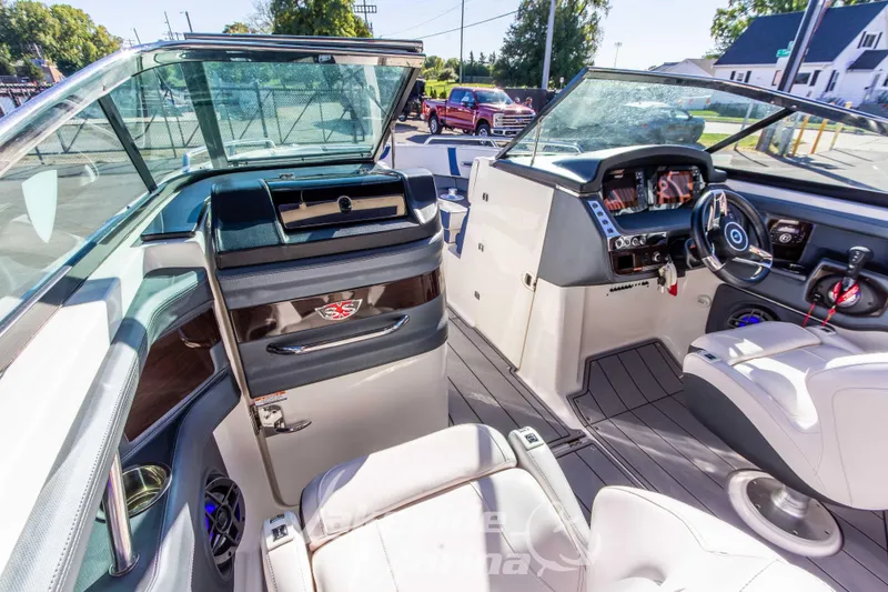 Slide: The Image of 2021 Chaparral 267 SSX boat interior with modern dashboard and seating. - 27