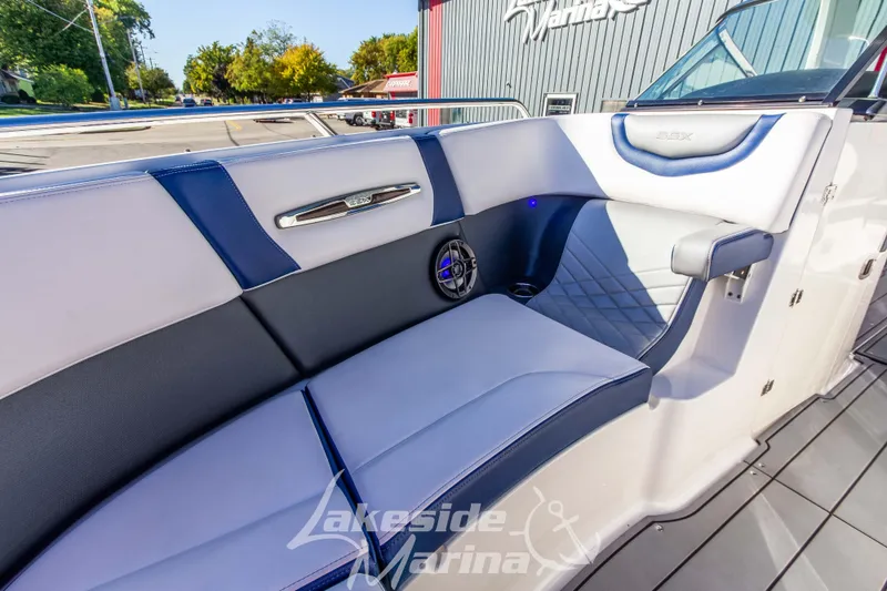 Slide: The Image of Interior of 2021 Chaparral 267 SSX boat with blue and white seating at Lakeside Marina. - 36
