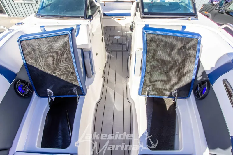 Slide: The Image of 2021 Chaparral 267 SSX boat interior with blue accents and seating. - 37