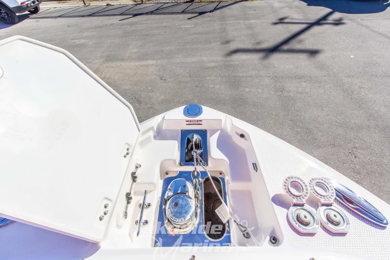 Slide: The Image of 2021 Chaparral 267 SSX boat anchor compartment with open hatch and chain. - 40