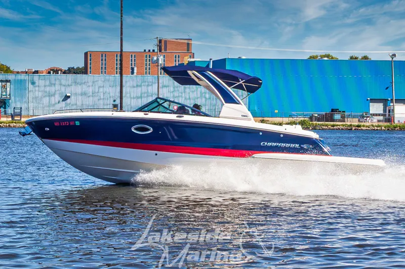 Slide: The Image of 2021 Chaparral 267 SSX boat detail with chrome hardware in a parking lot. - 42