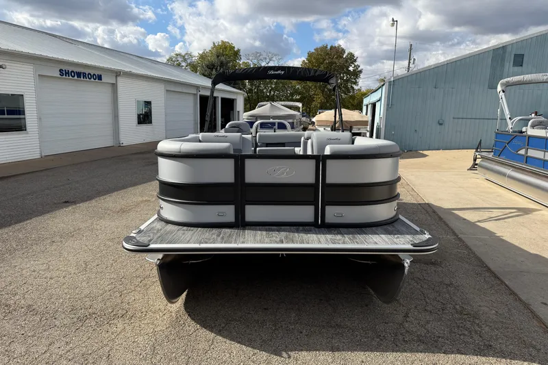 Slide: The Image of 2026 Bentley Pontoons Legacy 220 Cruise XL at a showroom, rear view. - 2