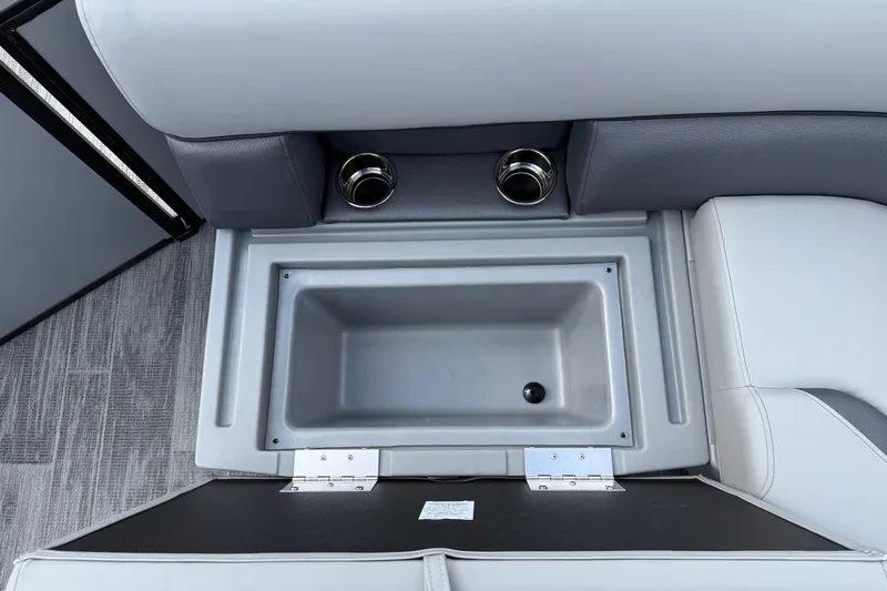 Slide: The Image of 2026 Bentley Pontoons Legacy 220 Cruise XL interior storage compartment with cup holders. - 21