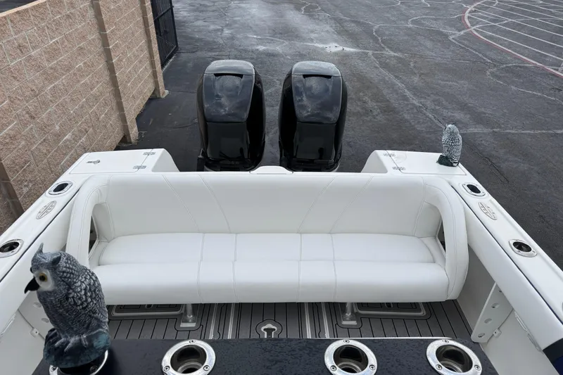 Slide: The Image of 2001 Intrepid 327 Center Console boat with white seating and dual engines. - 13