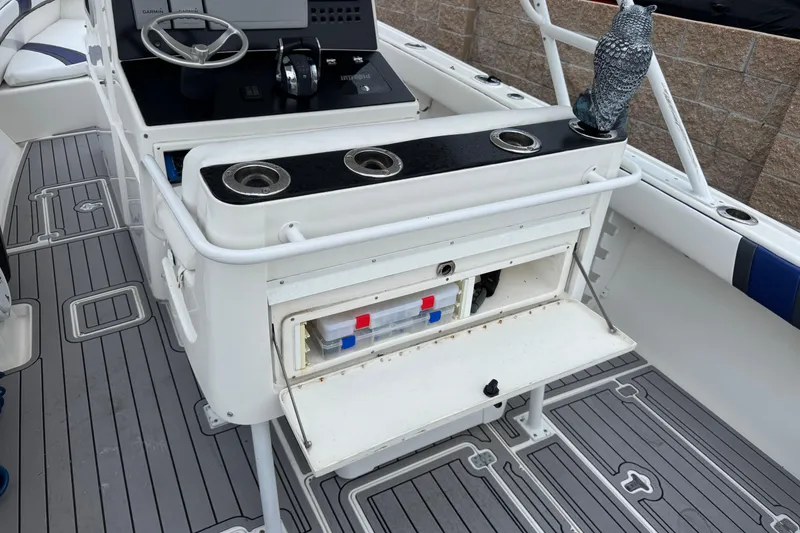 Slide: The Image of 2001 Intrepid 327 Center Console boat interior with steering wheel and storage compartment. - 14