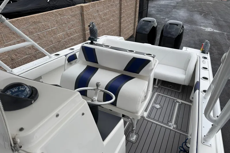 Slide: The Image of 2001 Intrepid 327 Center Console boat interior with seating and dual engines. - 12