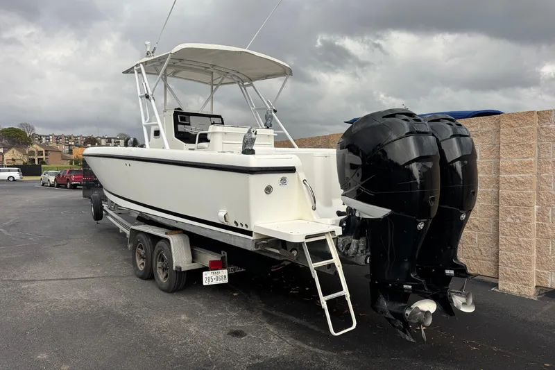 Slide: The Image of 2001 Intrepid 327 Center Console boat with dual outboard motors on a trailer. - 2