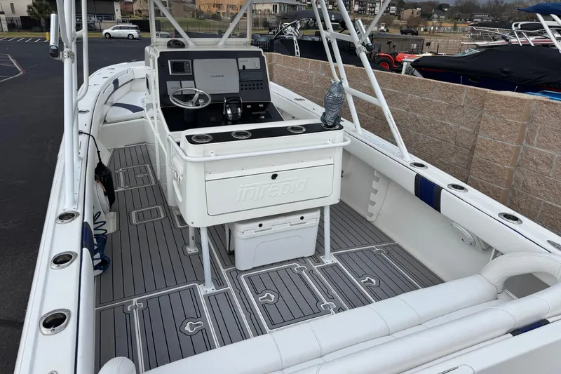 Slide: The Image of 2001 Intrepid 327 Center Console boat with sleek design and modern dashboard. - 4