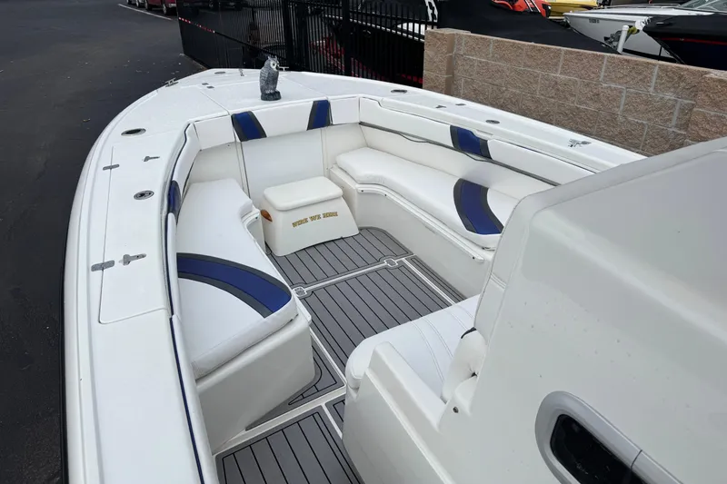 Slide: The Image of 2001 Intrepid 327 Center Console boat interior with white and blue seating. - 8