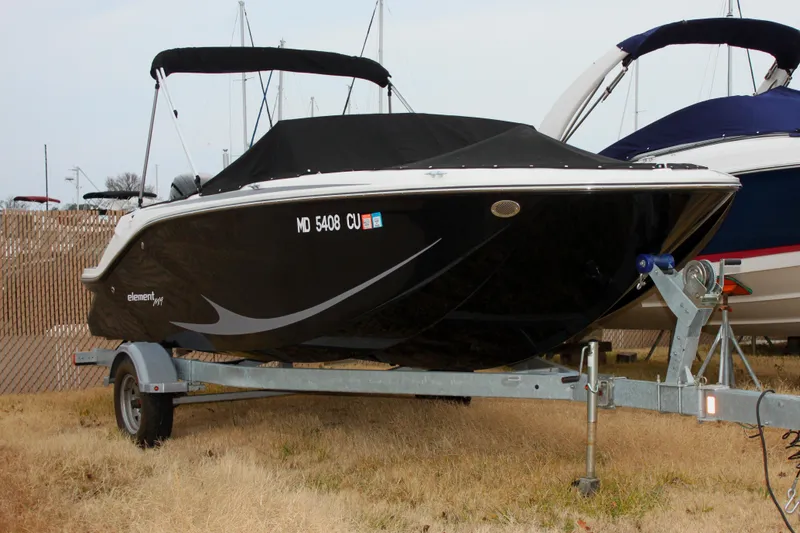 Slide: The Image of 2023 Bayliner Element M19 boat on calm water with a person onboard. - 1