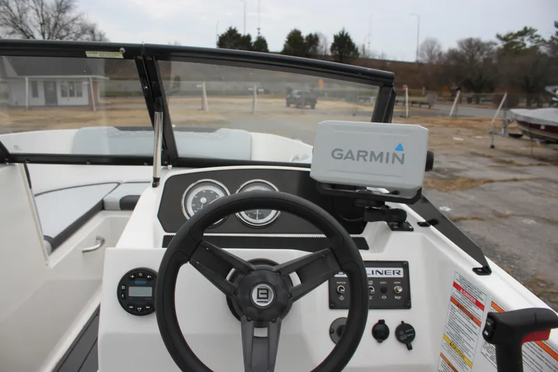 Slide: The Image of 2023 Bayliner Element M19 boat interior with steering wheel and dashboard controls. - 13