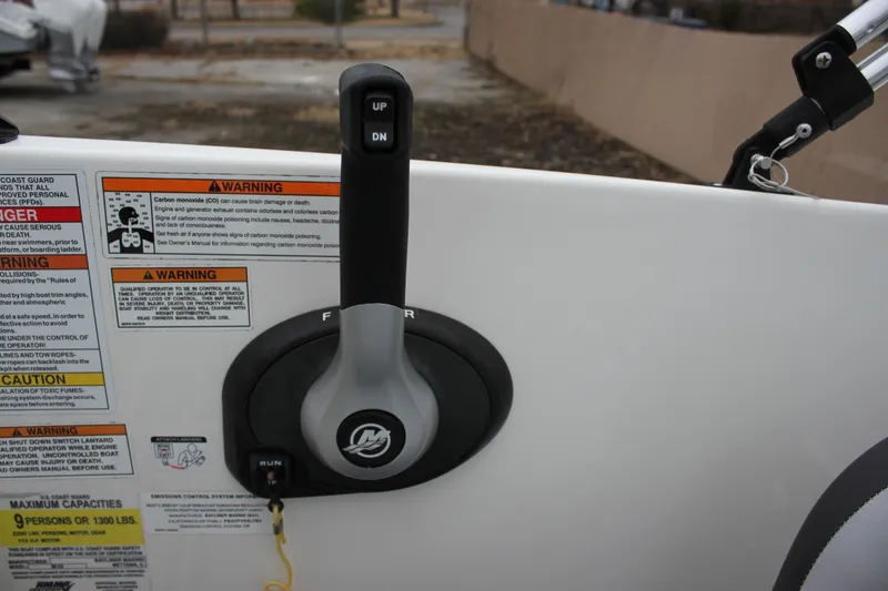 Slide: The Image of 2023 Bayliner Element M19 boat interior with cushioned seating and storage area. - 19