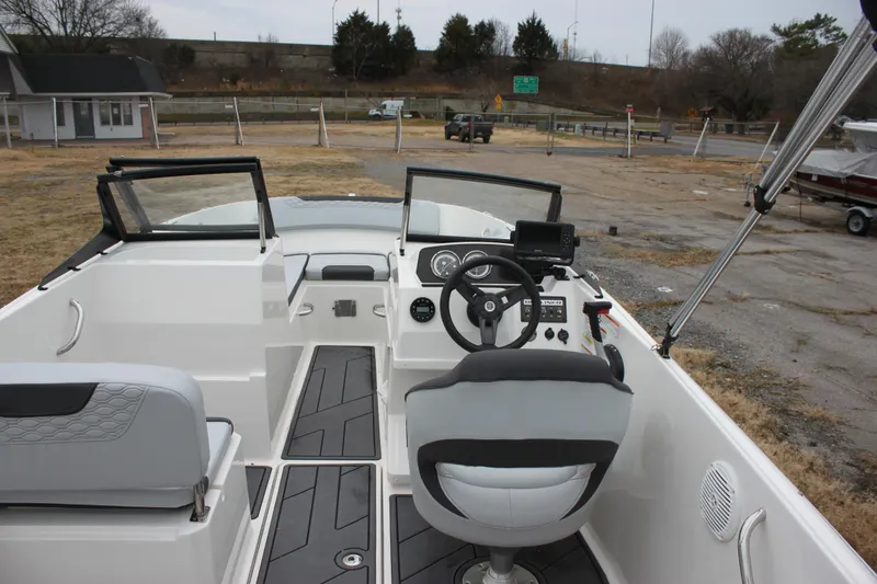 Slide: The Image of 2023 Bayliner Element M19 boat on water, featuring sleek black design and outboard motor. - 2