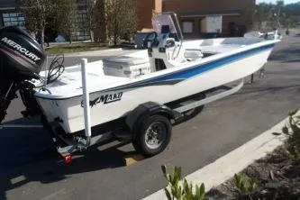 Slide: The Image of 2019 Mako Pro Skiff 17 CC boat on trailer, parked outdoors. - 3