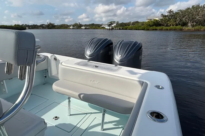 Slide: The Image of 2023 Contender 28 Sport boat with dual Yamaha engines on a calm river. - 10