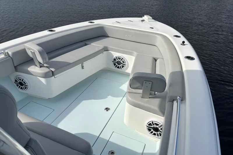 Slide: The Image of 2023 Contender 28 Sport boat interior with cushioned seating and speakers. - 13