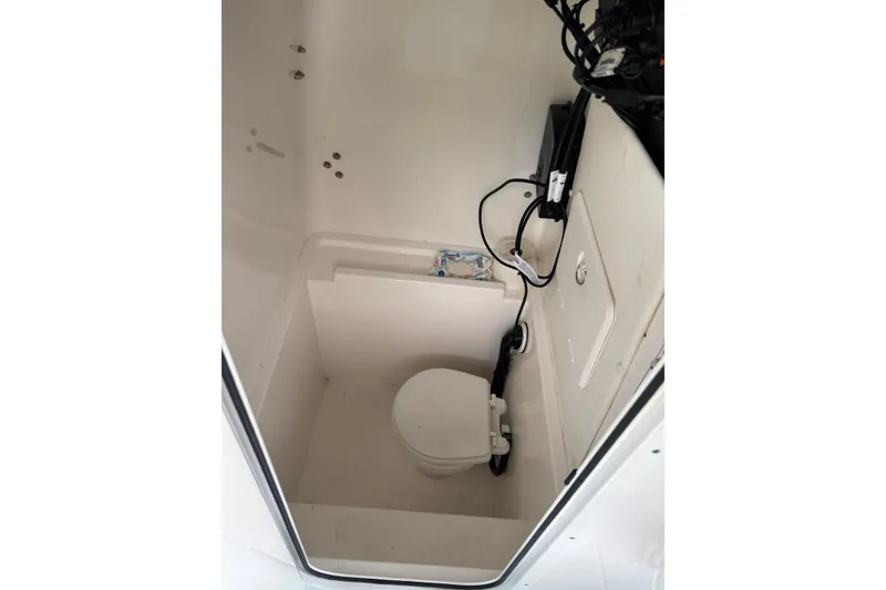 Slide: The Image of 2023 Contender 28 Sport boat interior with compact marine toilet. - 14