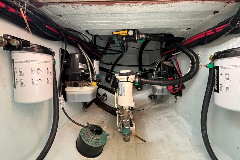 Slide: The Image of Engine compartment of 2023 Contender 28 Sport boat, showcasing filters and wiring. - 15