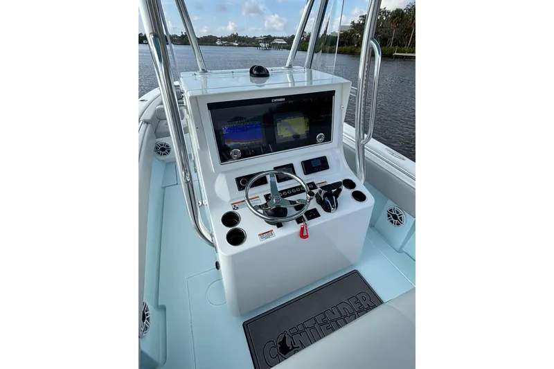 Slide: The Image of 2023 Contender 28 Sport boat console with steering wheel and navigation system. - 5
