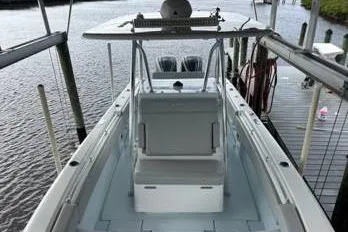 Slide: The Image of 2023 Contender 28 Sport boat docked, showcasing spacious deck and seating. - 7