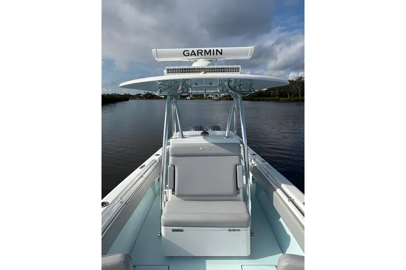 Slide: The Image of 2023 Contender 28 Sport boat with Garmin equipment on a calm waterway. - 8