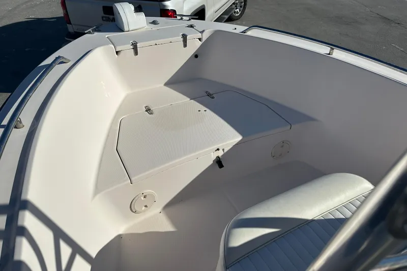 Slide: The Image of 2004 Grady-White Sportsman 180 boat interior with seating and storage compartments. - 14