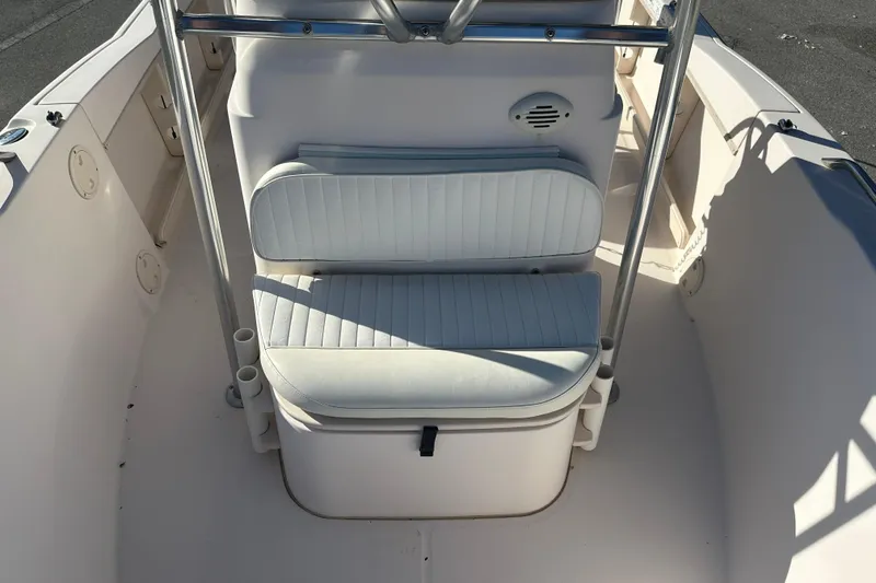 Slide: The Image of 2004 Grady-White Sportsman 180 boat interior with cushioned seating and rod holders. - 16