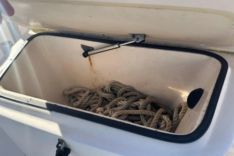 Slide: The Image of Open storage compartment with rope on a 2004 Grady-White Sportsman 180 boat. - 17